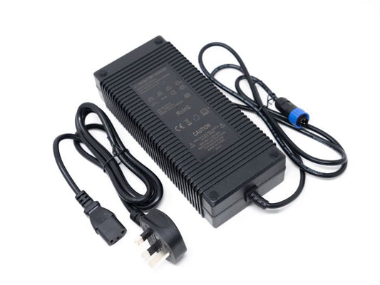 Front view of the Stomp Ebox stock charger showing its compact black rectangular design with attached power cable and indicator lights.