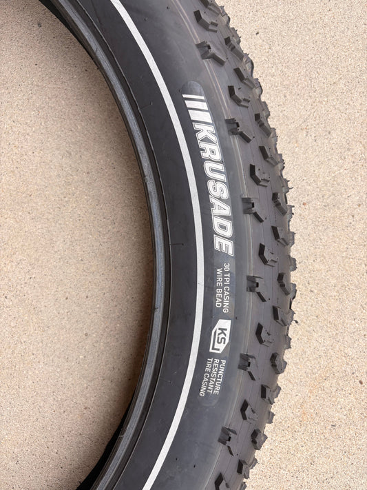 A 26x4 Kenda Krusade fat tire for eBikes with a reflective sidewall, shown in a product image.
