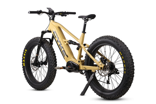 Desert yellow eBike Cyke Falcon X electric bicycle, side view, displayed outdoors