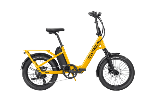 Velotric Fold 1 Plus electric bike in Mango color, folded for compact storage, side view on a white background