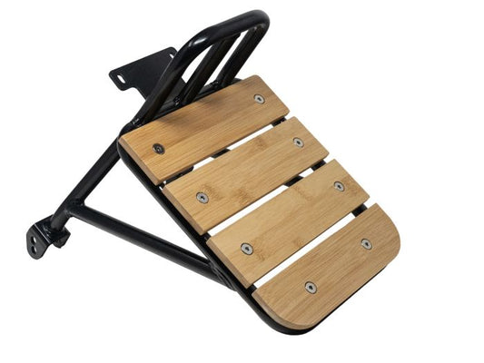 Stomp Ebox Dragster Carry Rack mounted on an electric dirt bike, side view, showing sturdy metal construction and attachment points.