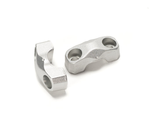 Close-up view of Stomp Ebox handlebar risers installed on a motorcycle, showing the black anodized finish and secure mounting hardware.